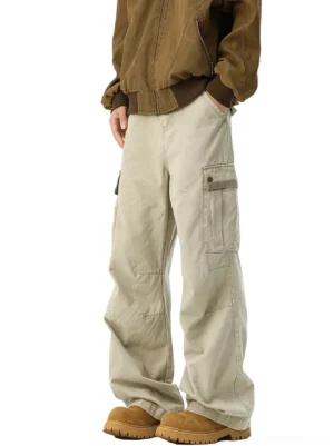 Light khaki washed cotton wide-leg cargo pants styled with a brown bomber jacket and tan platform boots, featuring oversized flap pockets and a relaxed streetwear silhouette