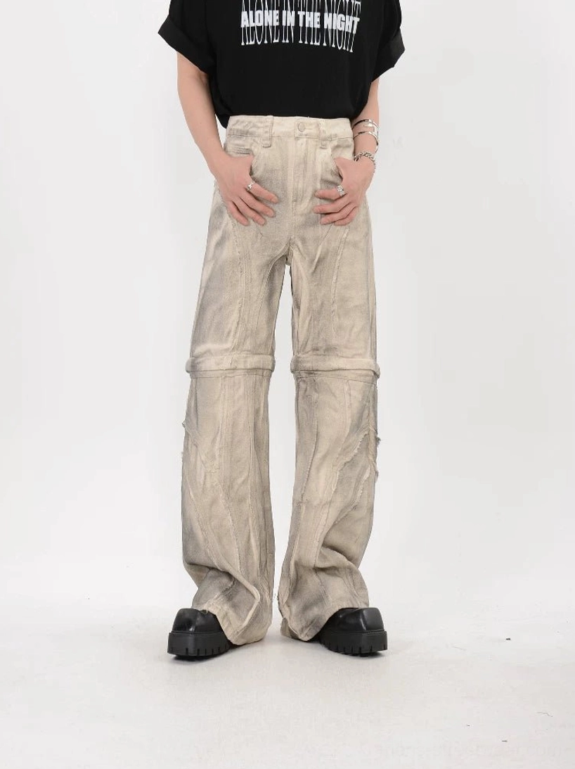 Full length front view of beige modular stacked flare pants fully assembled with faded wash and wide leg silhouette