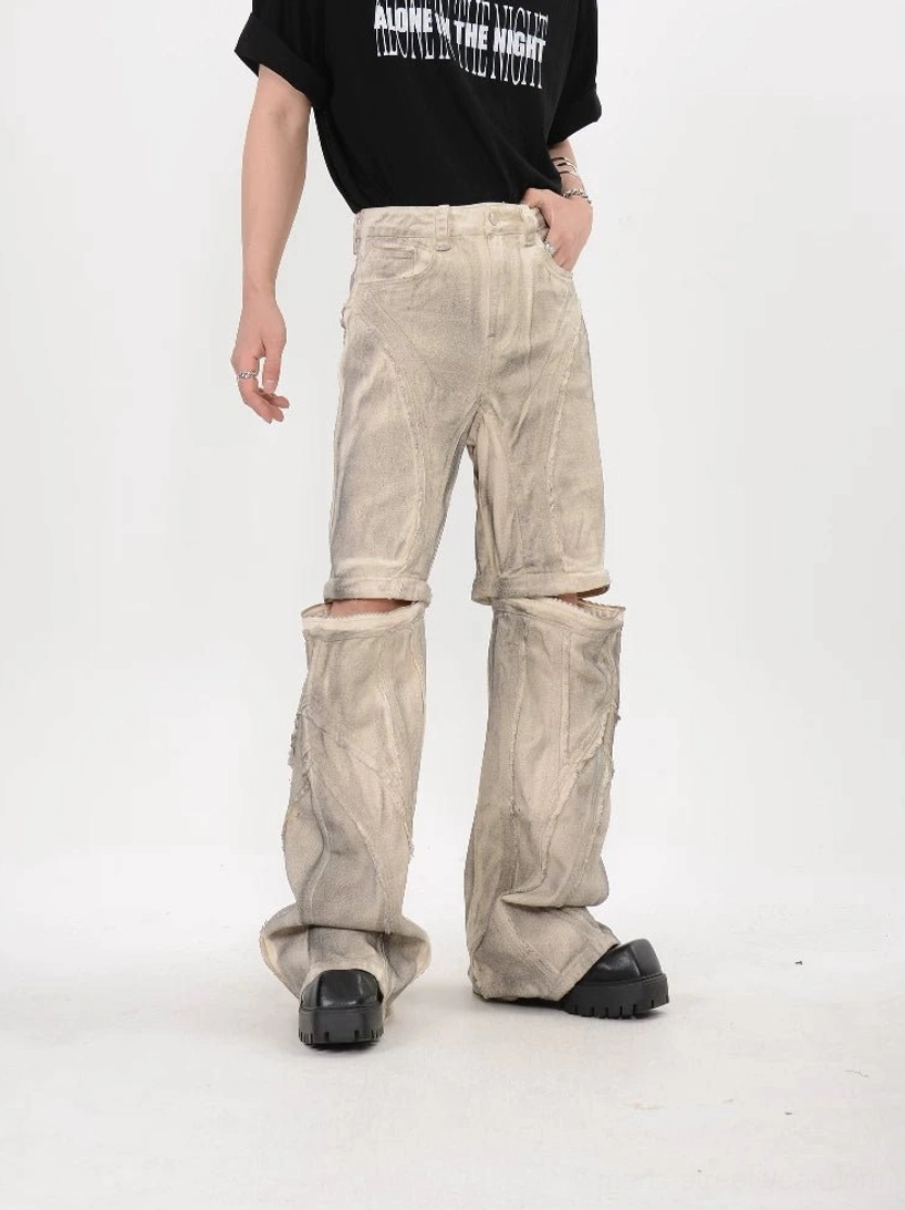 Front full body view of beige dune modular detachable stacked flare pants with split knee construction and washed streetwear finish