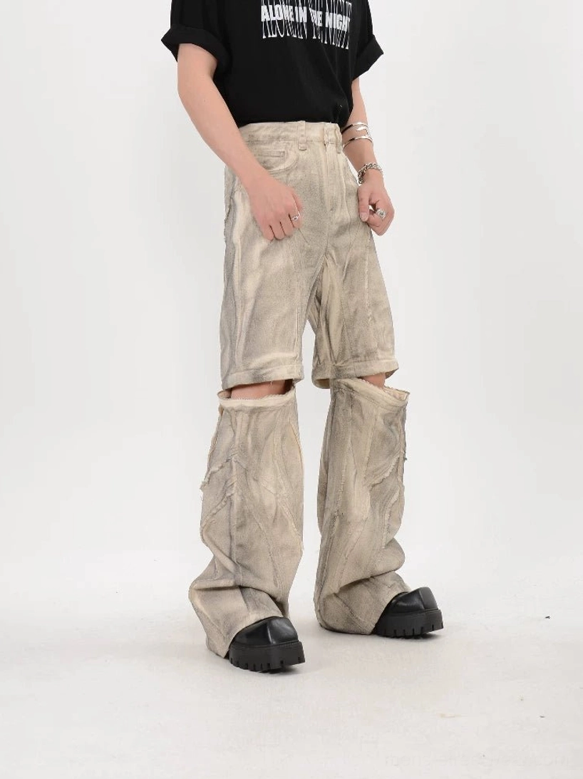 Front three quarter view of washed beige modular split knee pants showing classic pockets and detachable flare leg design