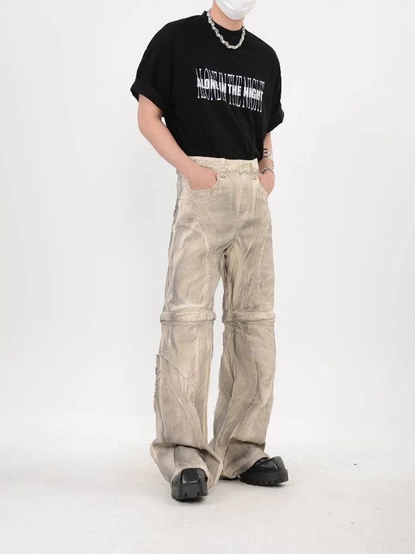 Three quarter streetwear outfit view of beige washed stacked flare pants with extended hems and wide leg construction