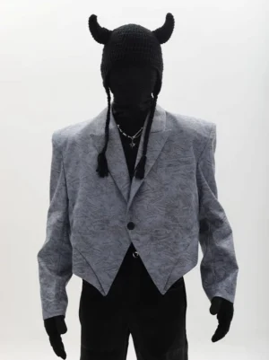 Dusty blue asymmetric cropped blazer with sharp pointed hem, padded shoulders and single button streetwear front view