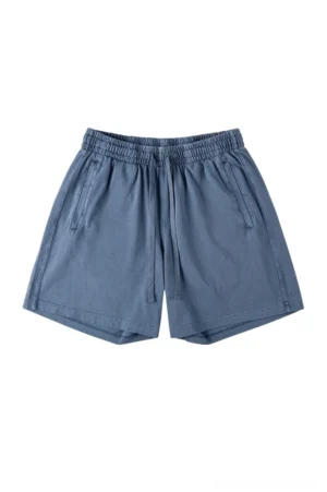 Dusty blue washed cotton oversized drawstring shorts with elastic waist side pockets and relaxed Korean streetwear silhouette