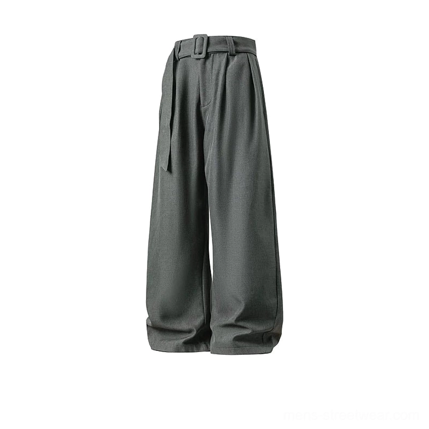 Flat product view of dusty grey belted curve trousers with front pleats, relaxed wide legs, and a full-length streetwear silhouette