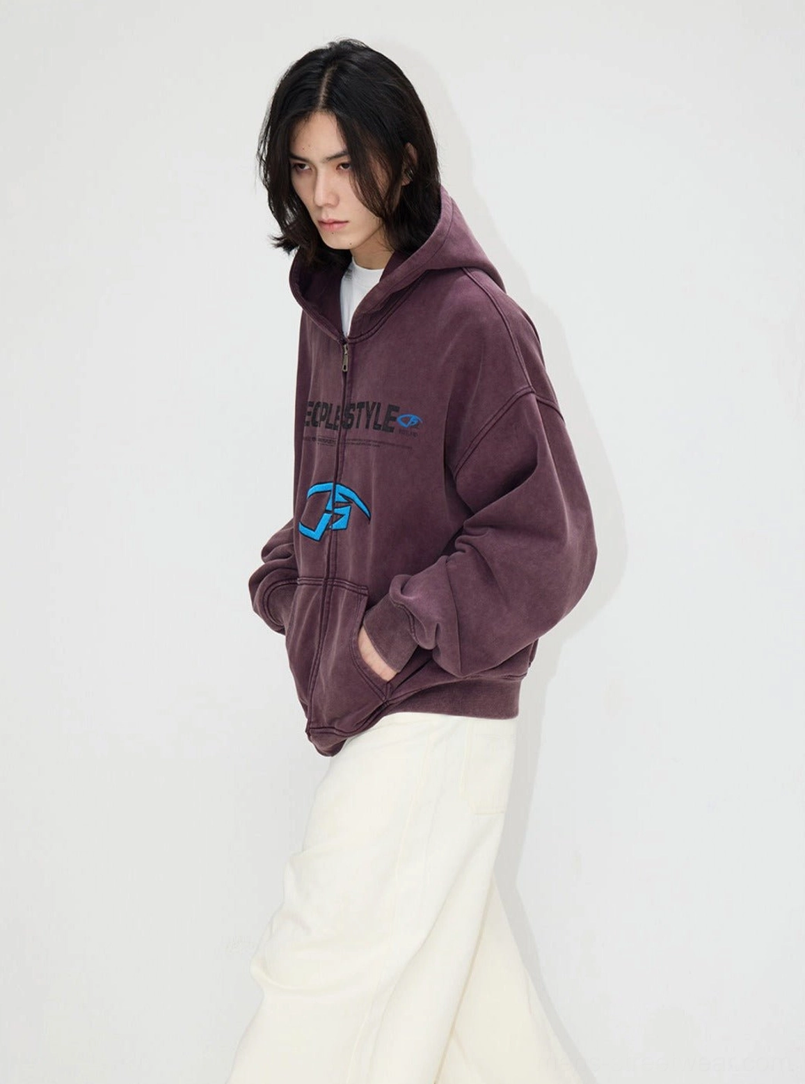 Side profile of an oversized dusty purple distressed zip-up hooded jacket with chest graphic print and relaxed streetwear styling