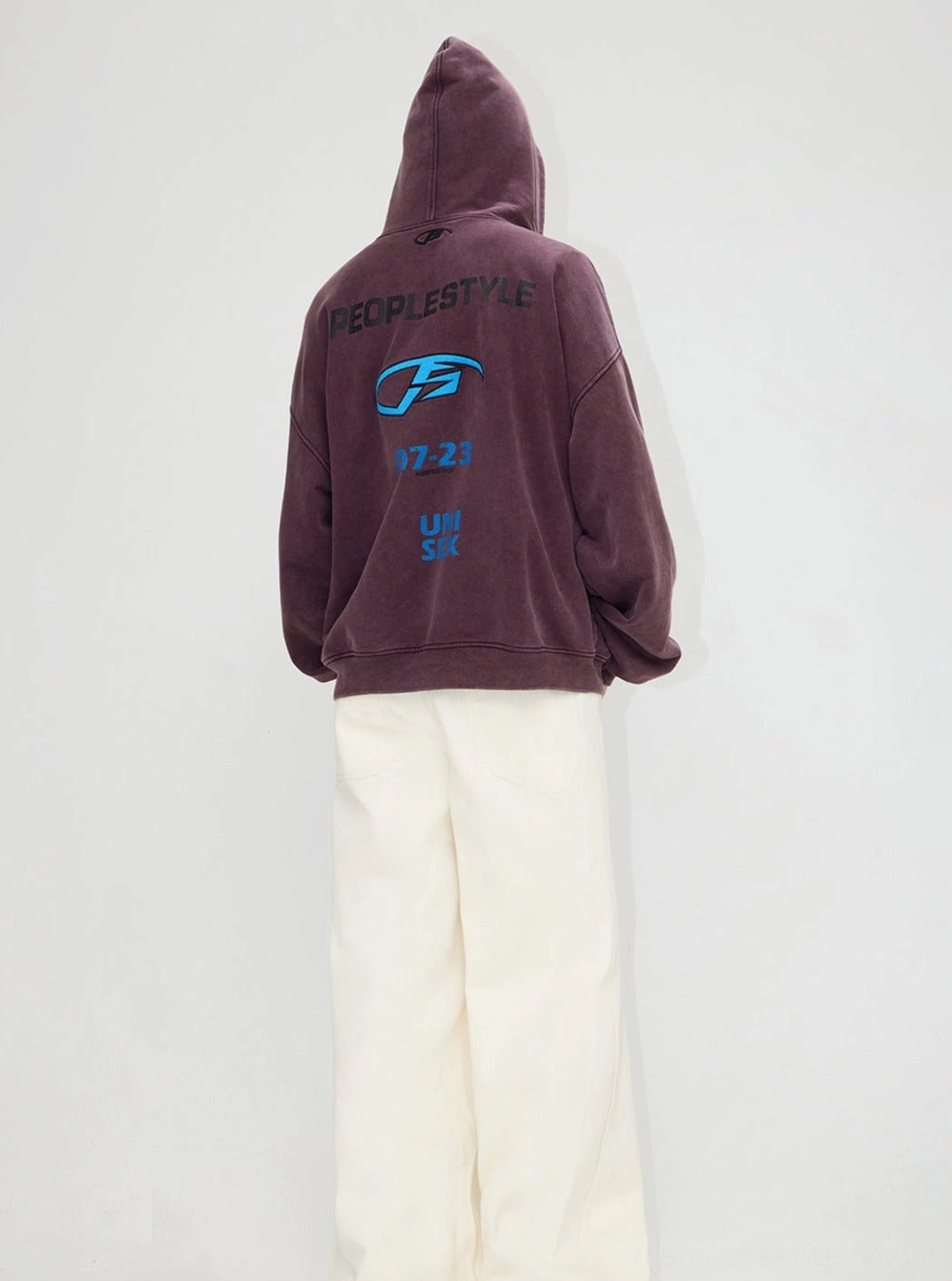 Back view of a dusty purple vintage distressed hooded streetwear jacket featuring large graphic prints and relaxed oversized proportions