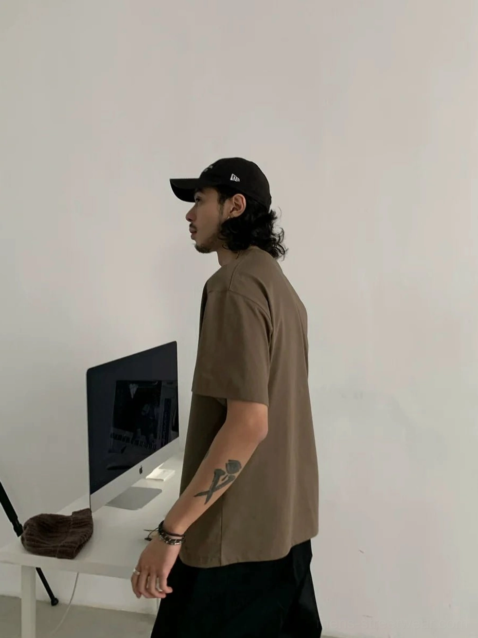 Earth brown minimalist crew neck cotton blend t-shirt shown in side profile with relaxed streetwear fit