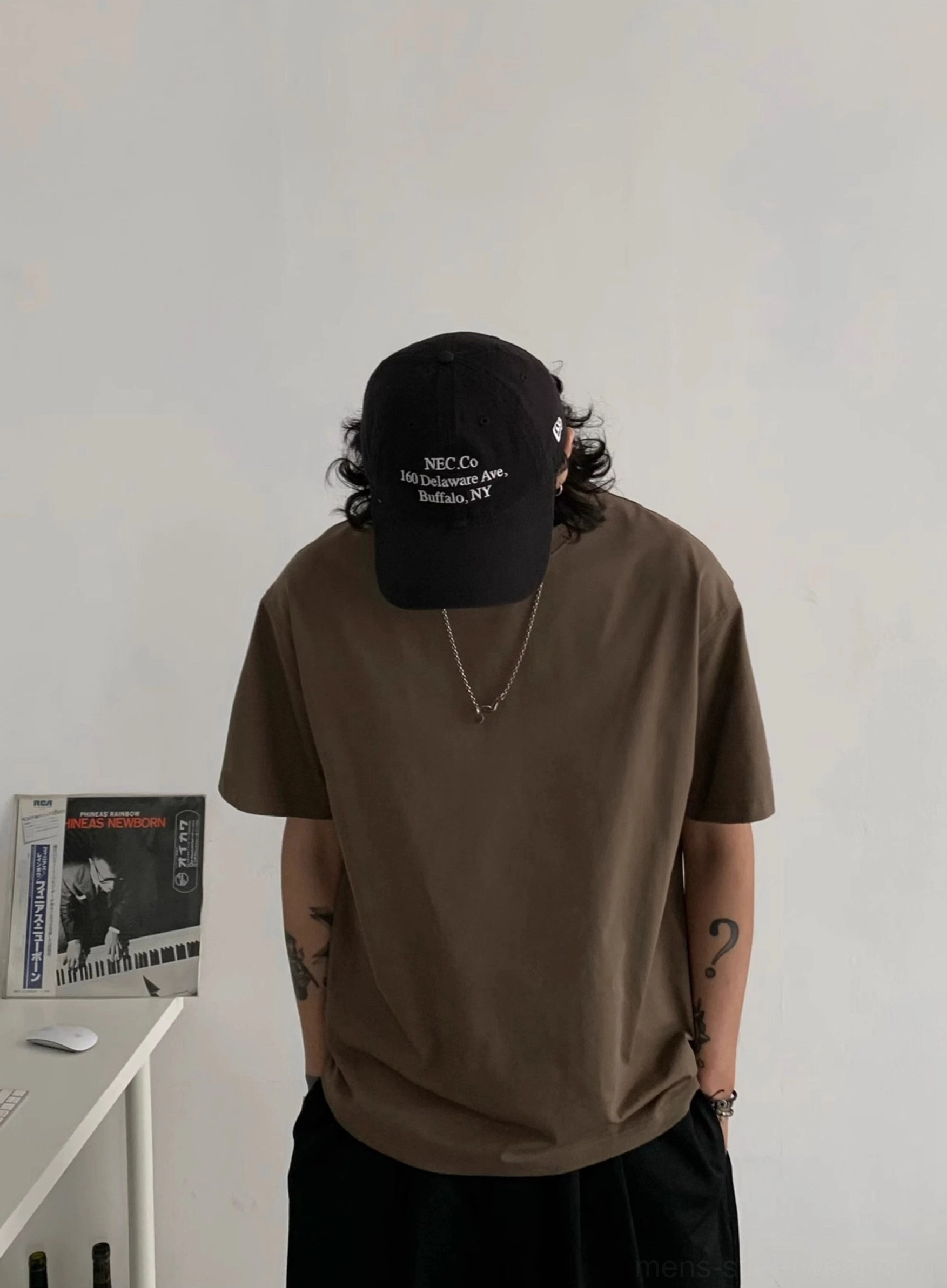 Earth brown relaxed crew neck t-shirt shown from the back with minimalist solid color streetwear styling
