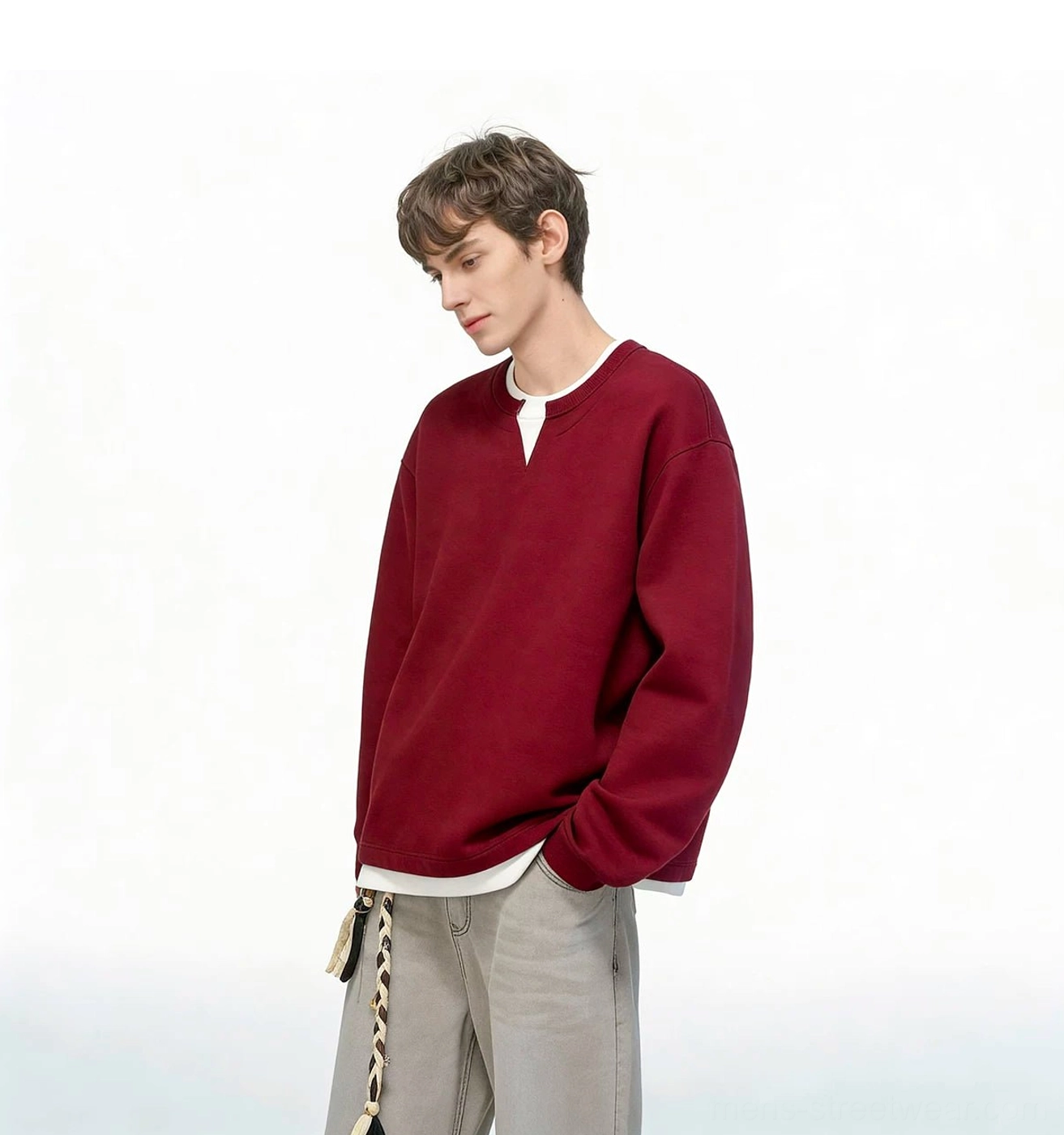 Contemporary East Asian streetwear sweatshirt for men featuring a loose fit, layered white hem, and minimalist crew neckline
