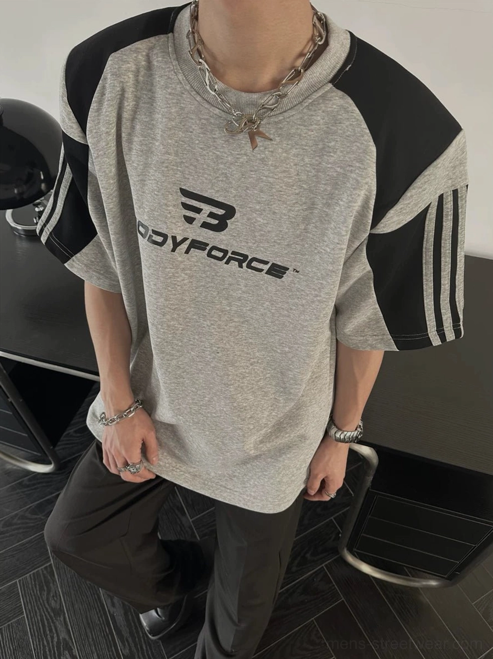 East Asian streetwear colorblock tee with relaxed proportions and sporty sleeve stripe accents