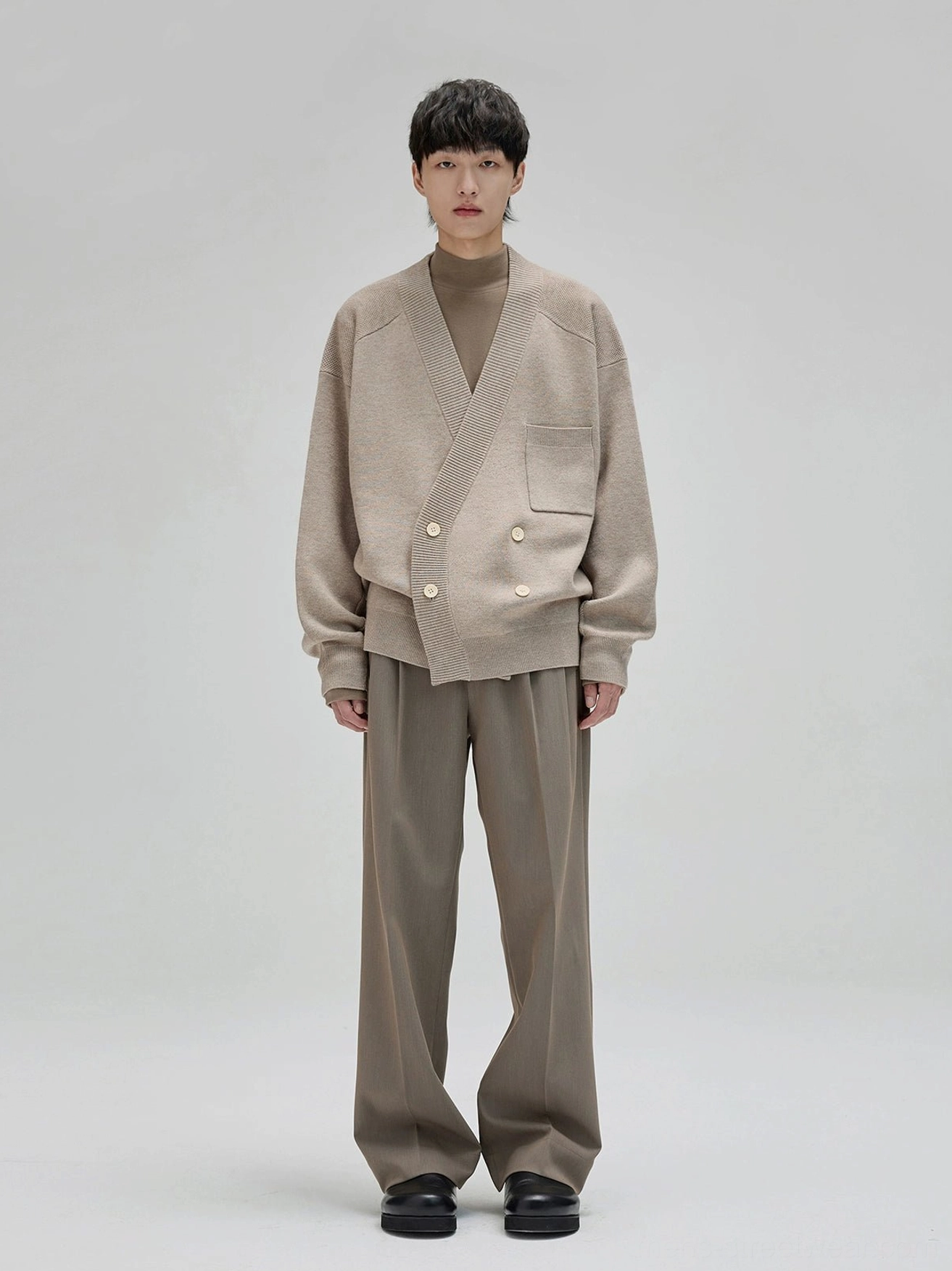 Beige knit cardigan styled with taupe gray wide leg suit pants for minimalist Korean streetwear