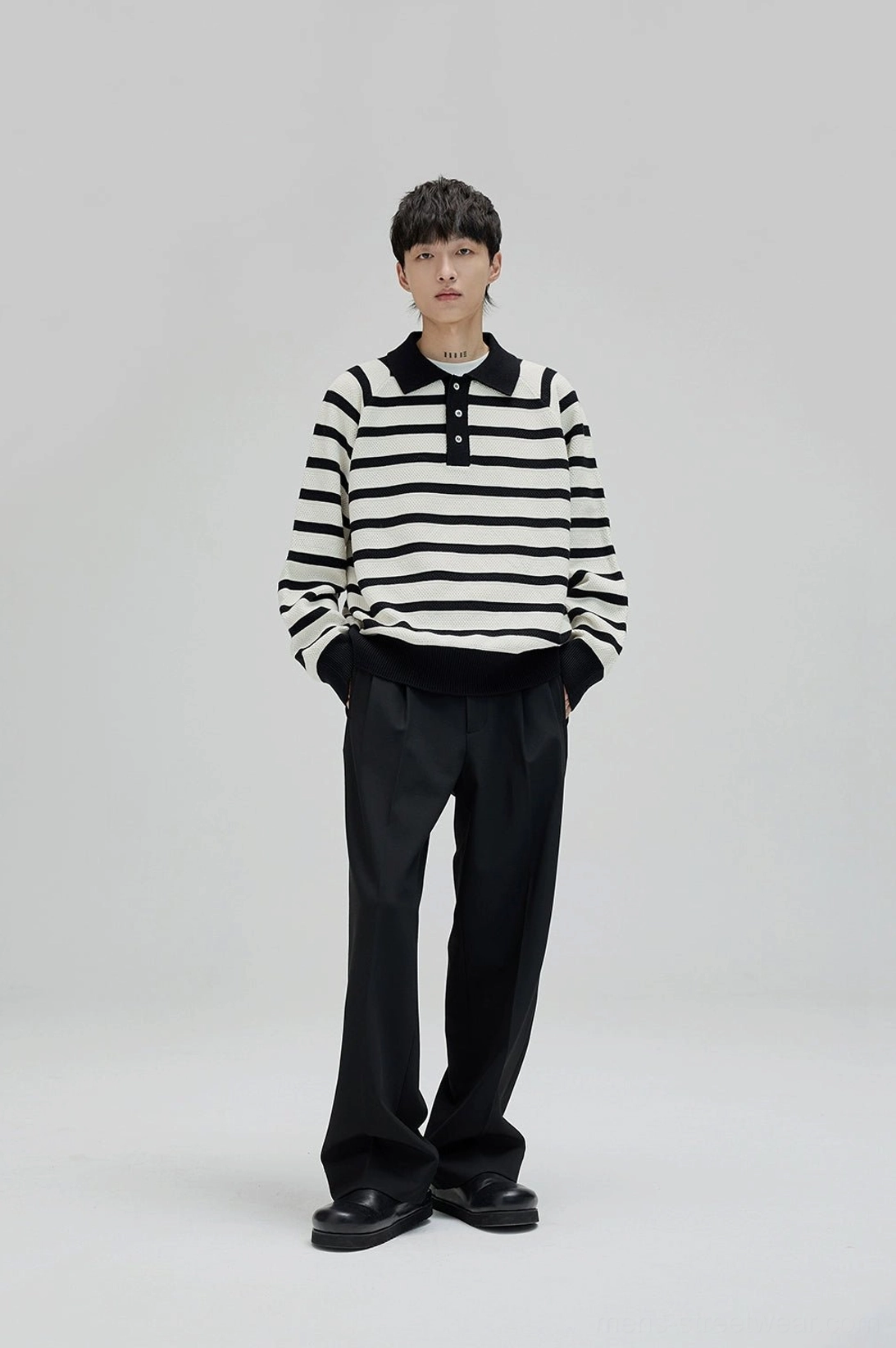 Black wide leg suit pants paired with striped polo knit sweater for smart casual Seoul street style