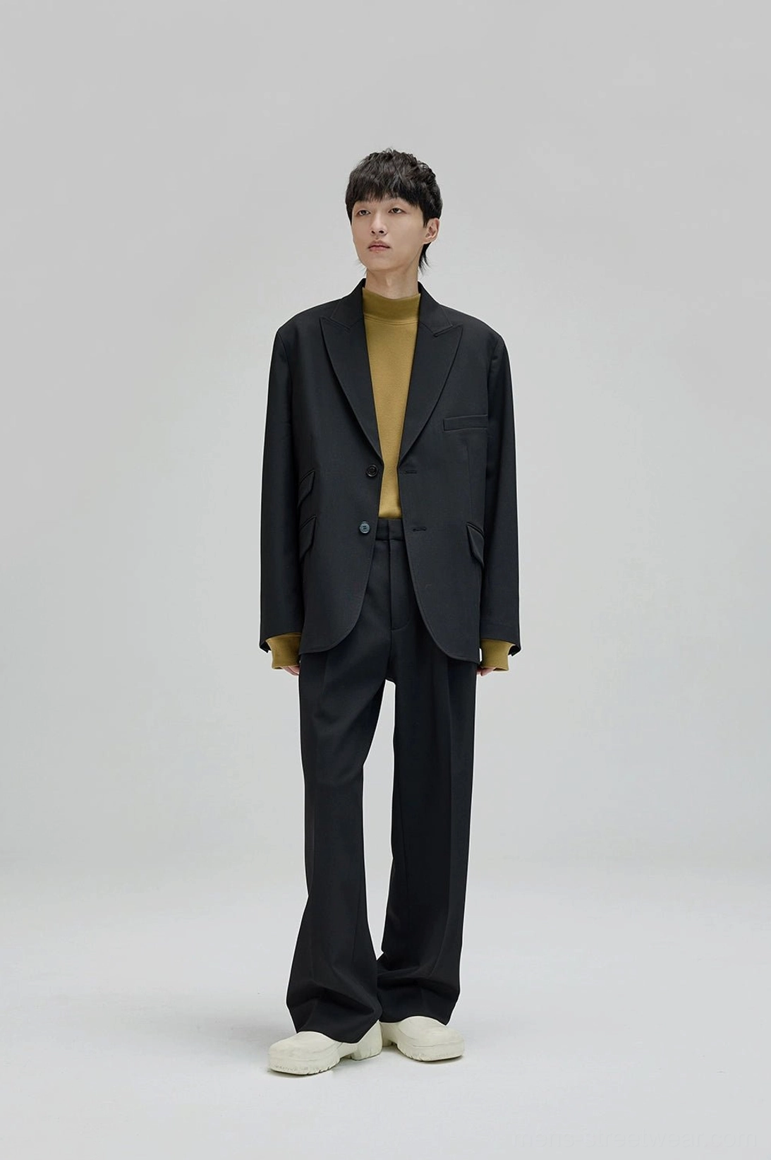 All black tailored suit with relaxed wide leg suit pants and notched lapel blazer for minimalist streetwear
