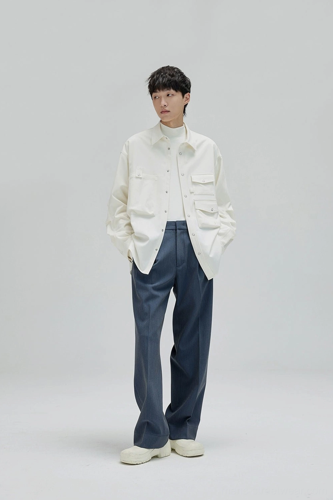 Wide leg pleated trousers with clean hems and relaxed movement for contemporary mens fashion