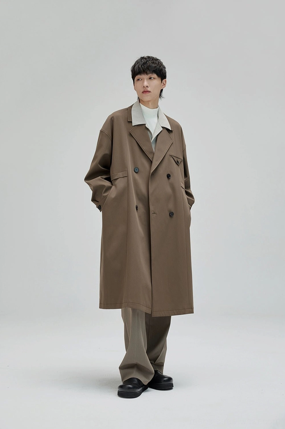 Contemporary wide suit pants with layered back pockets adjustable waist buttons and refined construction