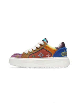 Multicolor embossed platform skate sneakers with purple orange and blue patchwork panels embroidered motifs frayed trims and thick white rubber outsole shown from the left side