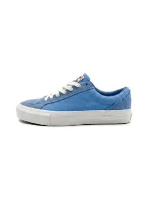 Sky blue embroidered low-top skate sneakers with suede-textured upper, white flat laces, and substantial rubber outsole shown from the side