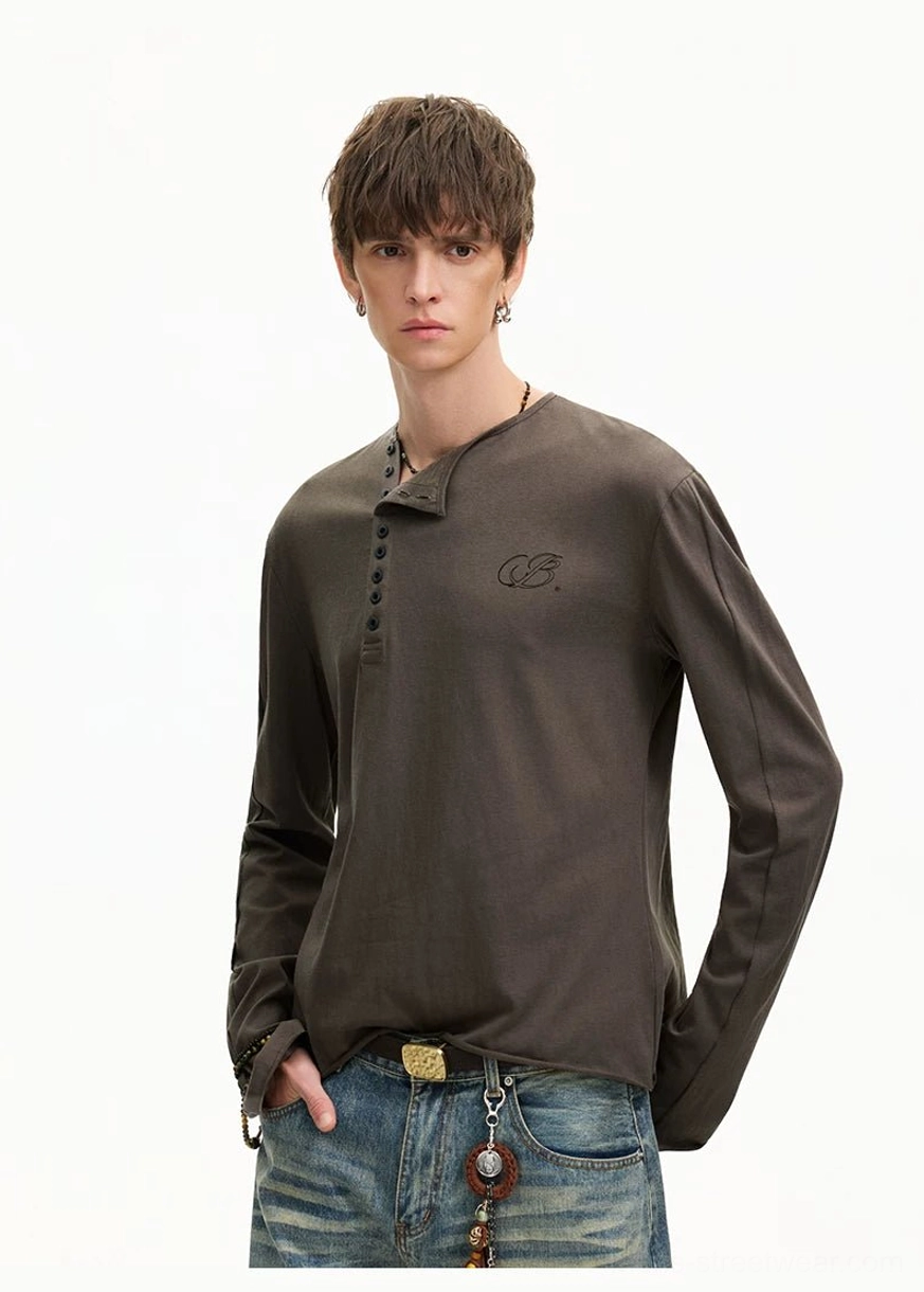 Three-quarter streetwear outfit featuring an espresso brown Henley long sleeve tee with vintage blue jeans and waist accessories