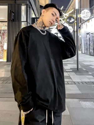 Black oversized long sleeve crew neck T-shirt styled in a relaxed urban streetwear outfit