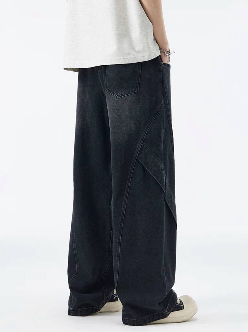 Faded black baggy wide-leg denim jeans back side view with vintage wash and panel seam construction
