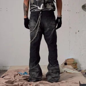 Rear view of faded black flared streetwear jeans featuring back pockets and double metal chain details