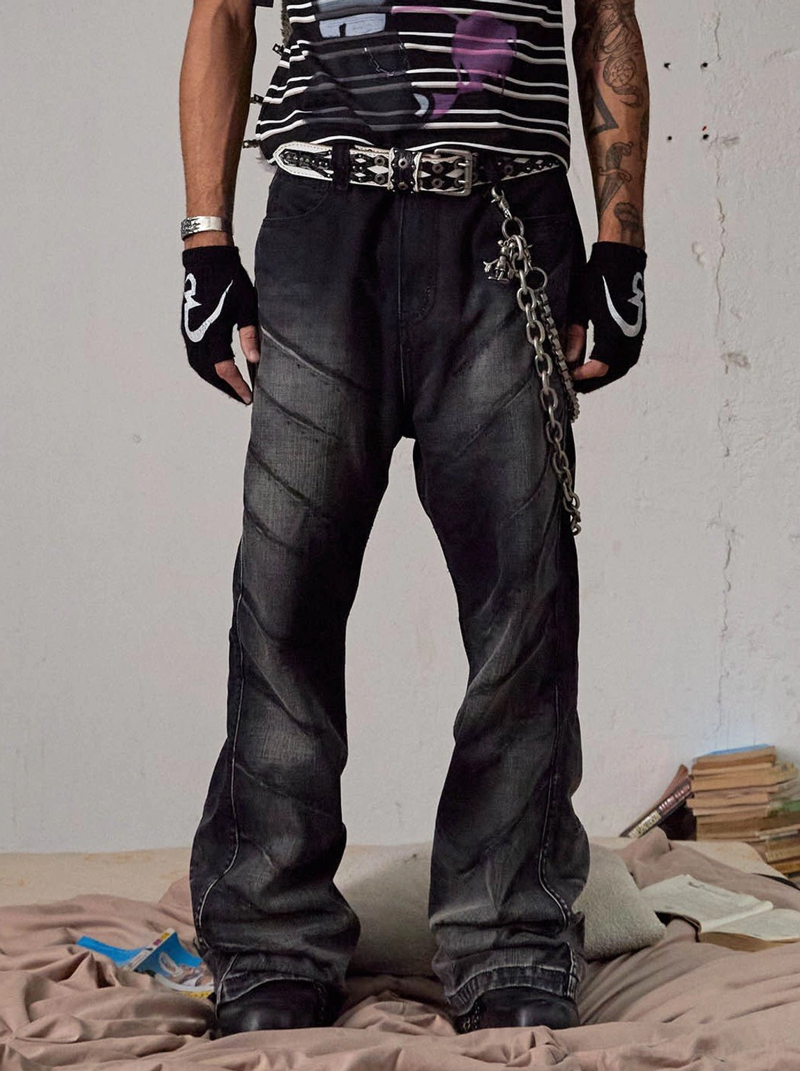 Front full-body view of faded black chain detail flared jeans with diagonal panel seams in Seoul streetwear styling