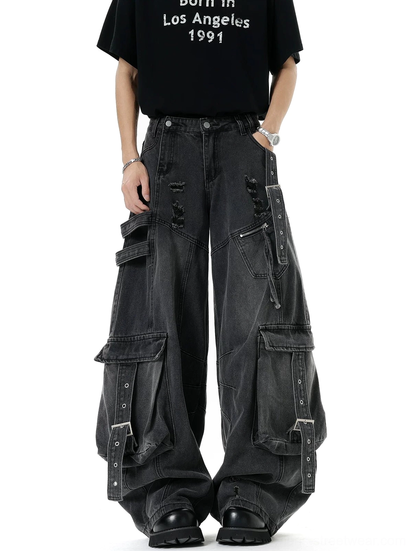 Faded black distressed cargo denim pants with multi-strap pockets, frayed details, and oversized wide leg Korean streetwear fit