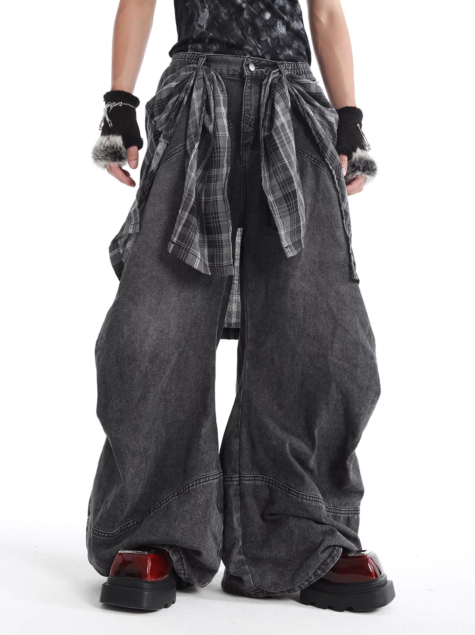 Front view of faded black balloon jeans with gray blue tartan layered waist detail and oversized alternative streetwear silhouette