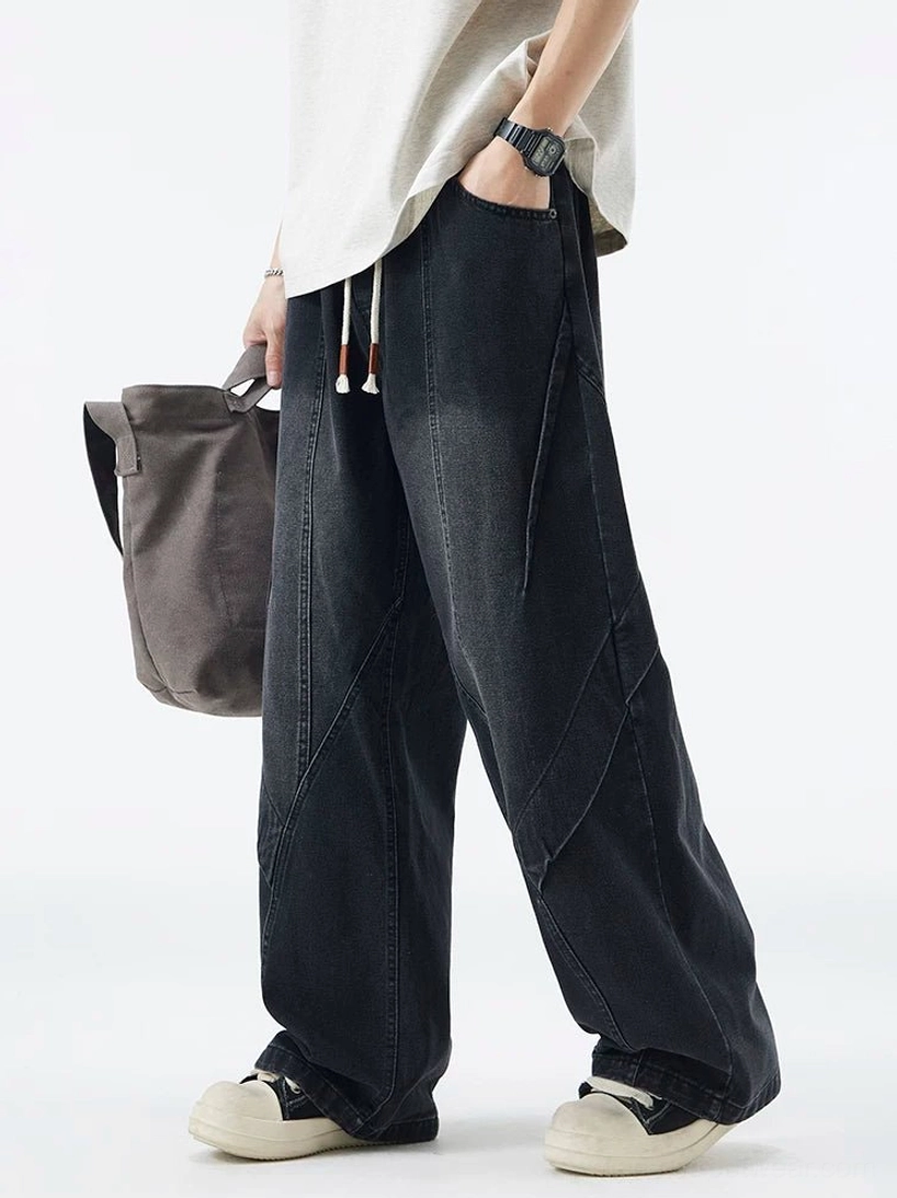 Faded black paneled drawstring wide-leg jeans side view styled with grey tote bag for Korean streetwear outfit