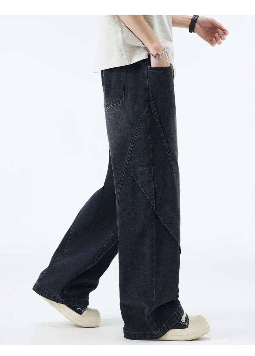 Faded black paneled wide-leg denim jeans walking side view with loose streetwear silhouette