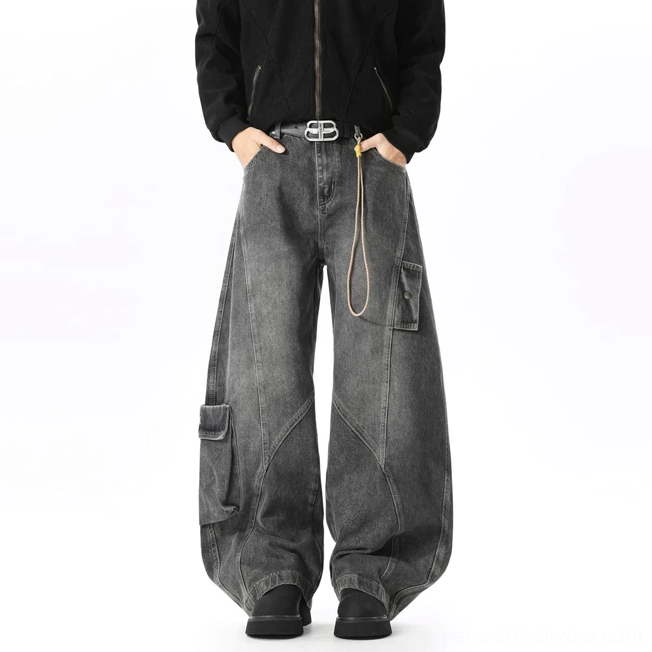 Faded black wide-leg cargo denim jeans shown in a full front view with black jacket, double-prong belt, side utility pocket, waist rope, and ultra-baggy silhouette