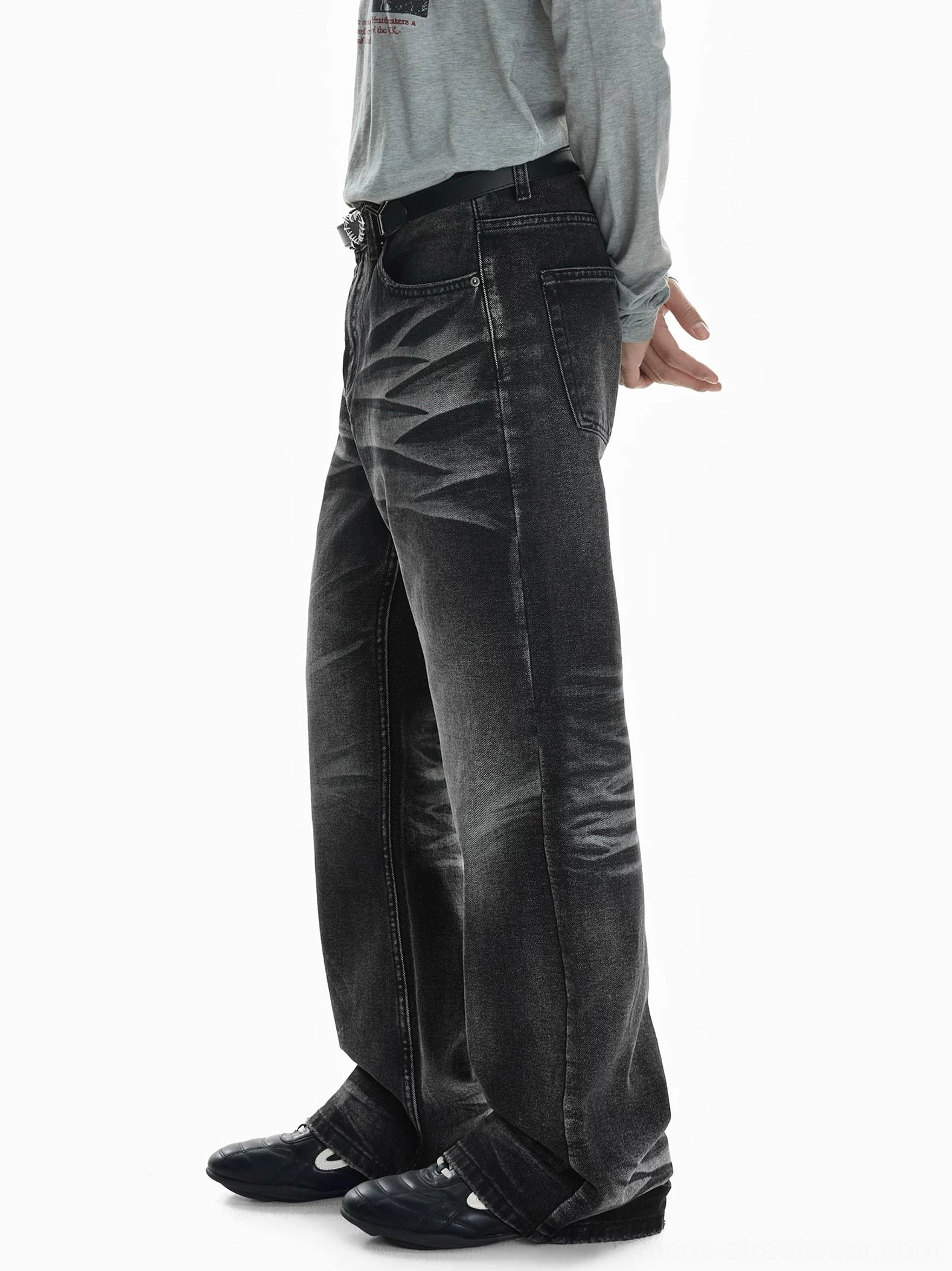 Right side profile of faded black wide-leg flare jeans showing clean side seams, relaxed mid-rise fit, stacked cuffs, and a vintage denim wash