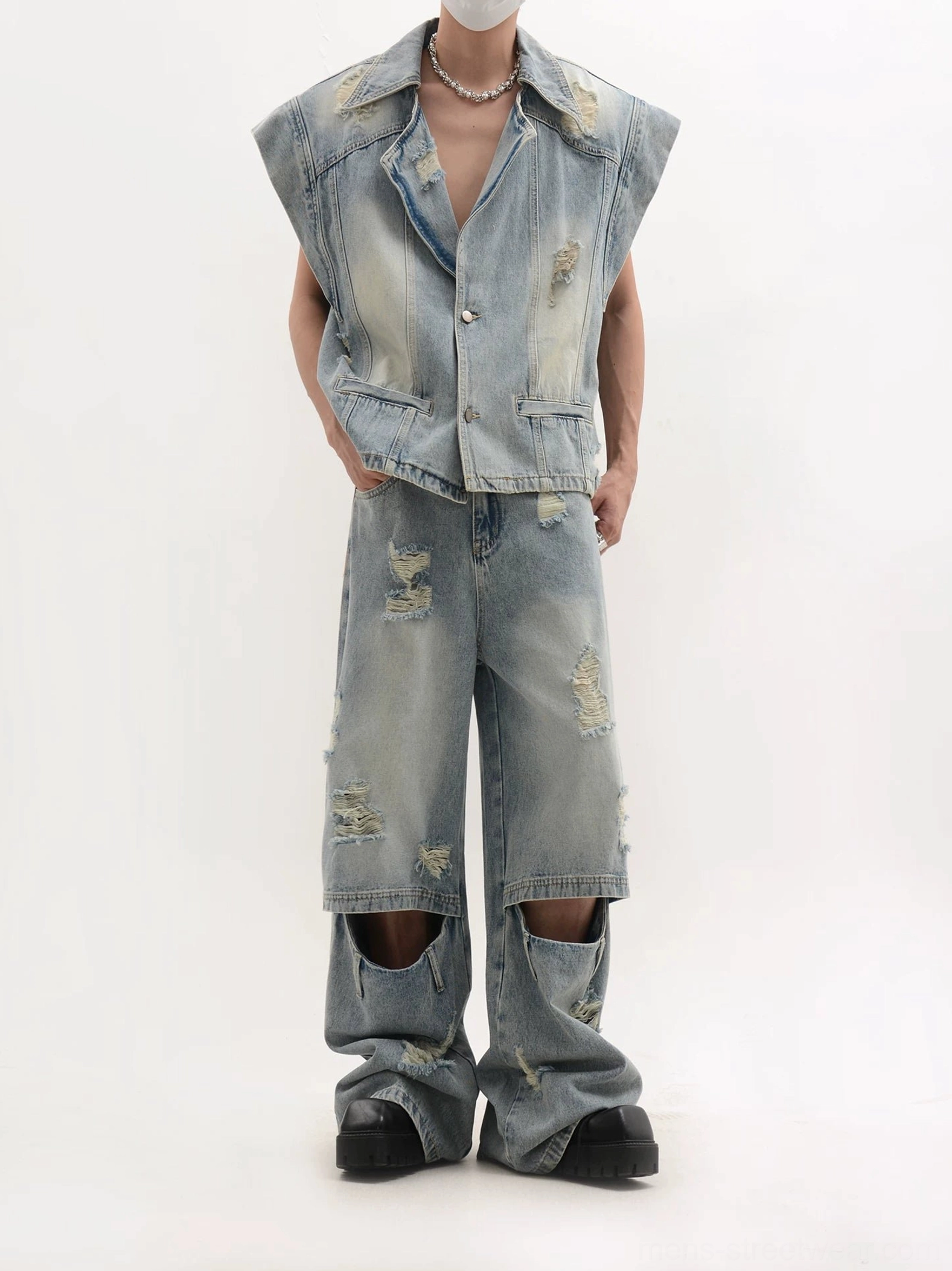 Full front view of a faded blue distressed denim coordinate set with oversized vest and ripped wide-leg trousers