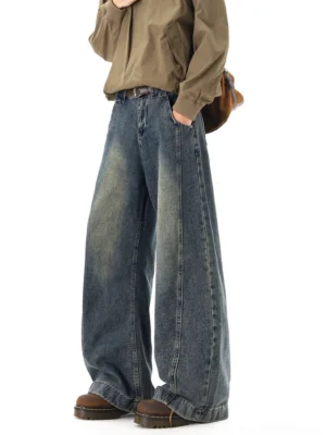 Faded blue wide-leg denim jeans side front view showing belt loops front pocket vintage wash and floor-length stacked fit