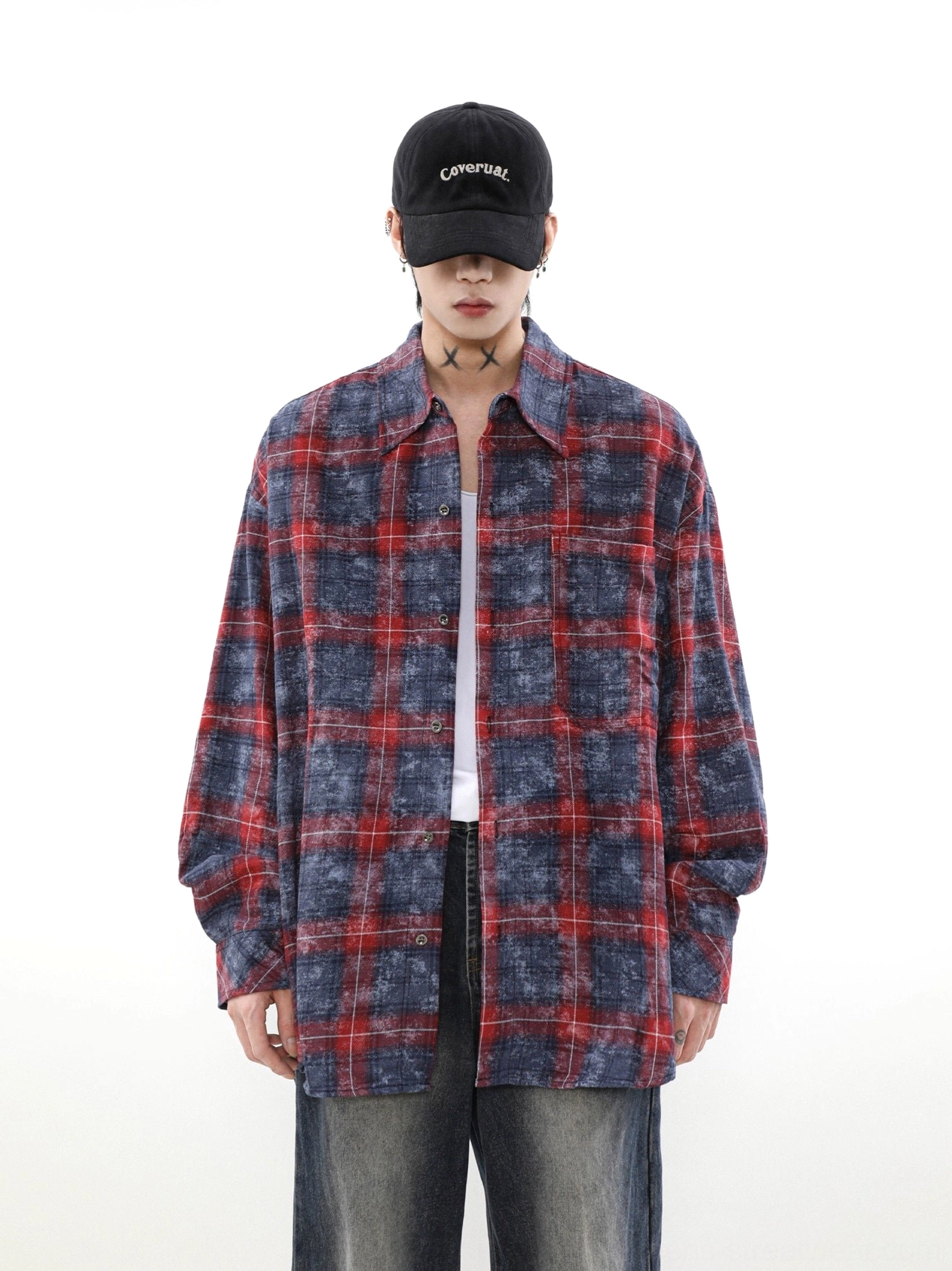 Faded red and navy plaid overshirt with classic collar styled over a white tee and dark jeans in vintage streetwear fashion
