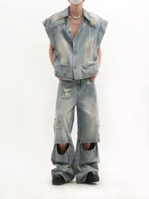 Back view of a faded vintage washed denim vest and matching ripped wide-leg jeans two-piece streetwear outfit
