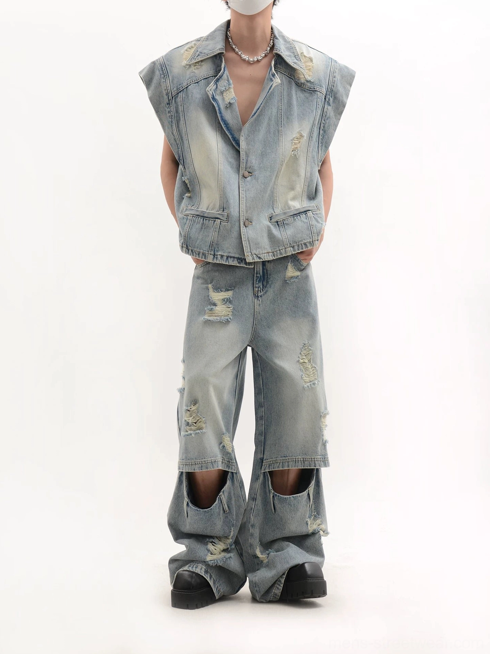 Back view of a faded vintage washed denim vest and matching ripped wide-leg jeans two-piece streetwear outfit