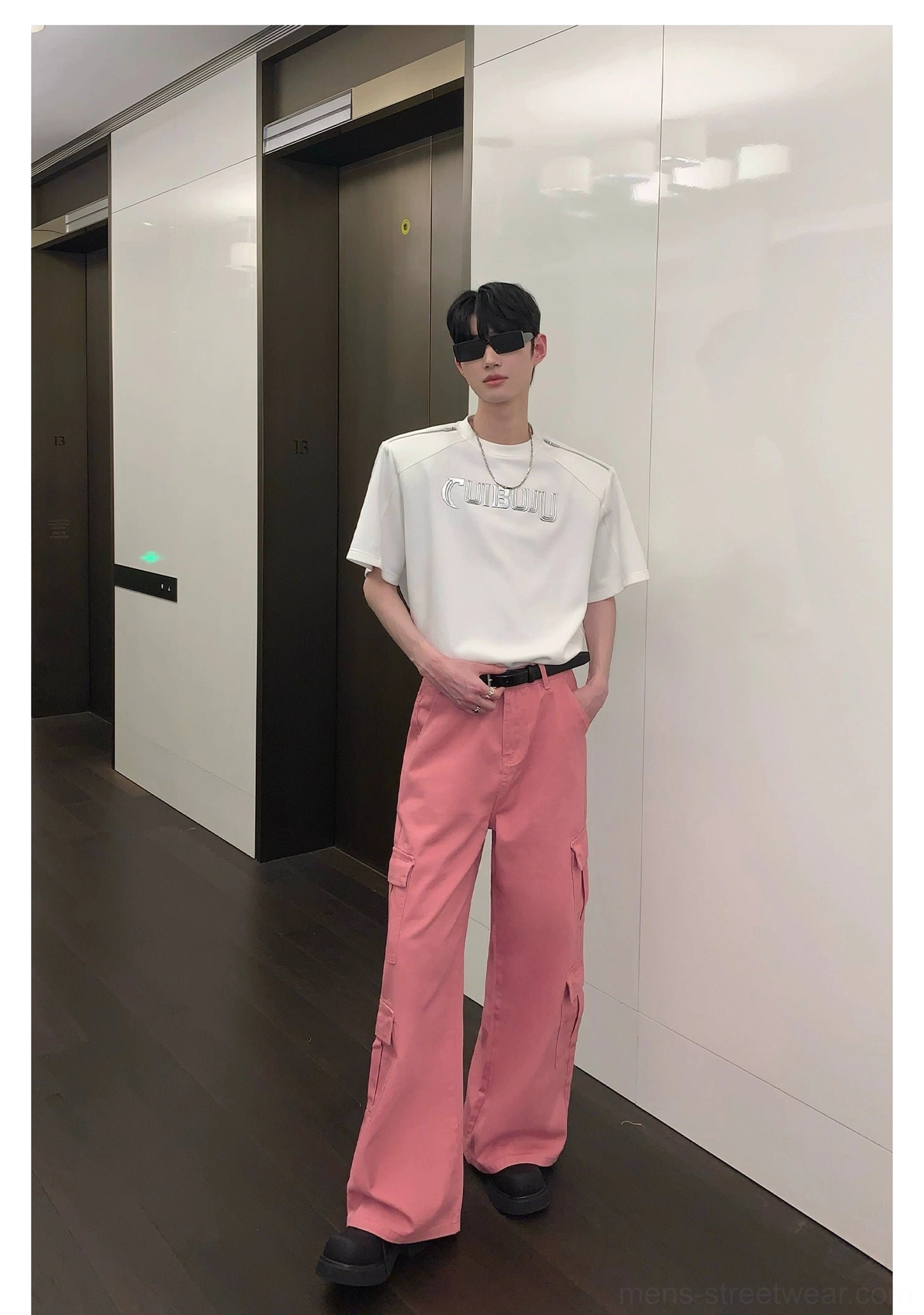Fashion-forward pink cargo pants with relaxed wide legs, utility pocket design, belt loops, and full-length streetwear cut