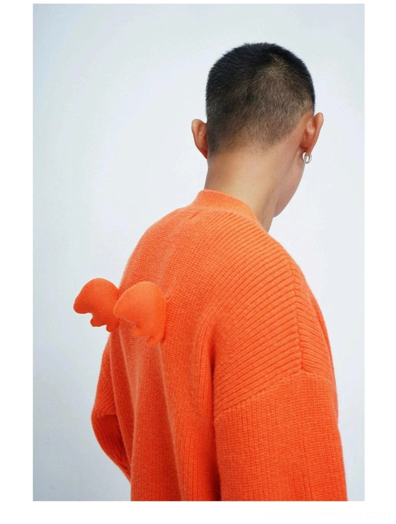 Fashion oversized cardigan with soft fuzzy knit texture, decorative pom-poms, V-neckline, and contemporary Seoul-inspired styling