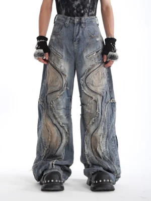 Front full-body view of faded blue deconstructed wide-leg denim jeans with curved raw-edge panels and vintage washed streetwear styling