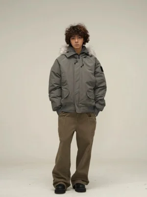 Dark grey faux fur hooded puffer bomber jacket front view styled with brown cargo pants