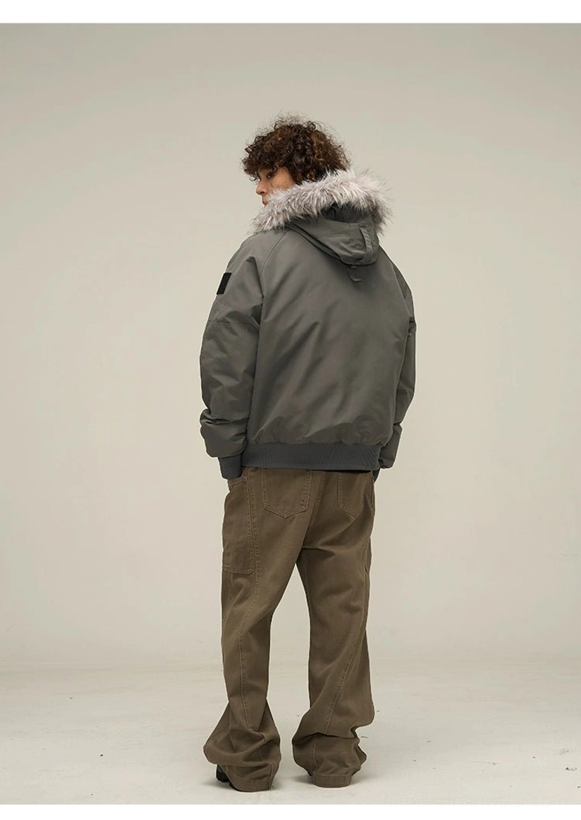 Dark grey hooded puffer bomber jacket rear side view showing relaxed cropped streetwear fit