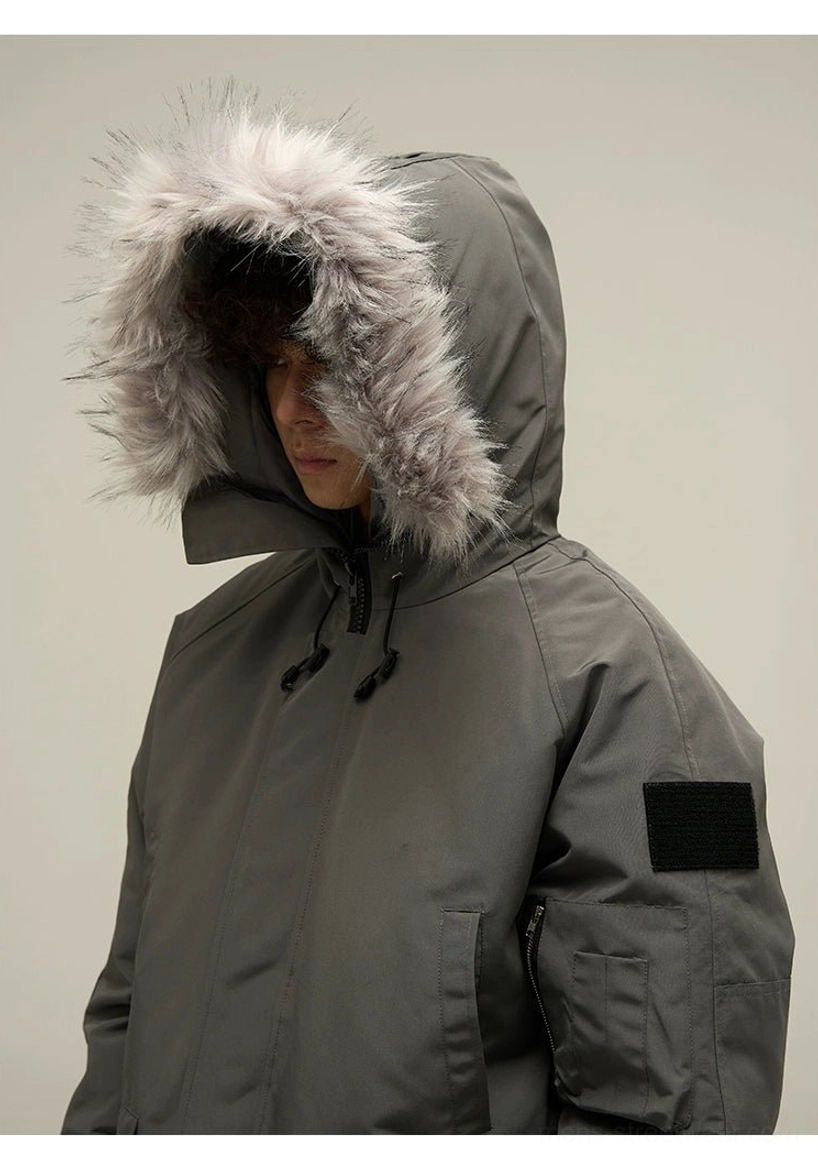 Close-up of dark grey faux fur trim hood and black utility sleeve patch on puffer bomber jacket
