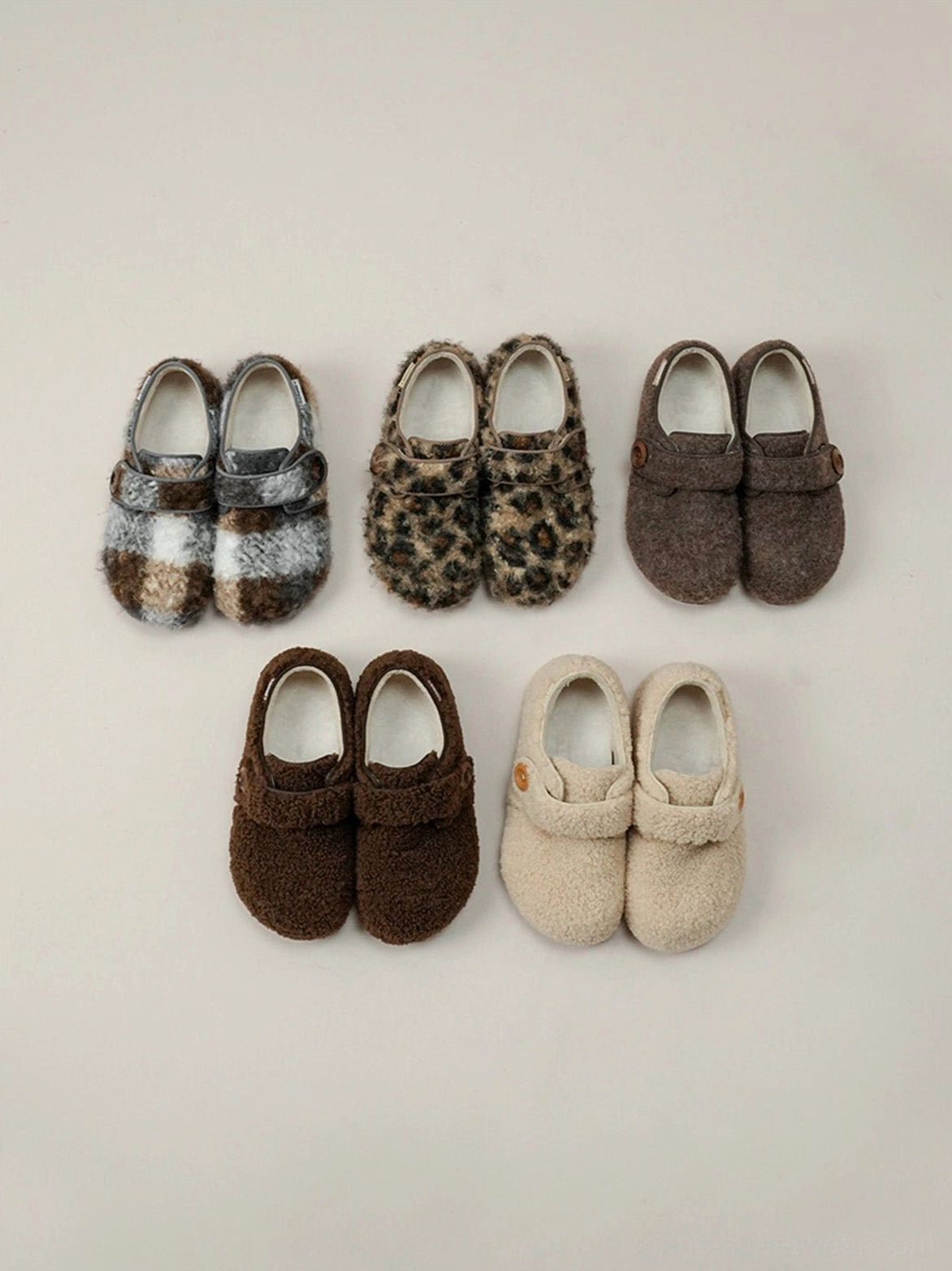 Top view of assorted faux fur Velcro slip-on shoes in leopard plaid coffee and neutral colorways