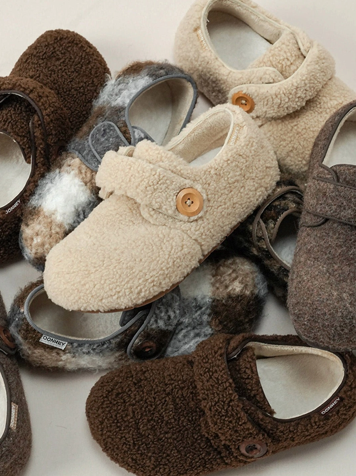 Close-up of faux fur Velcro slip-on shoe textures, button closures, and soft fleece lining