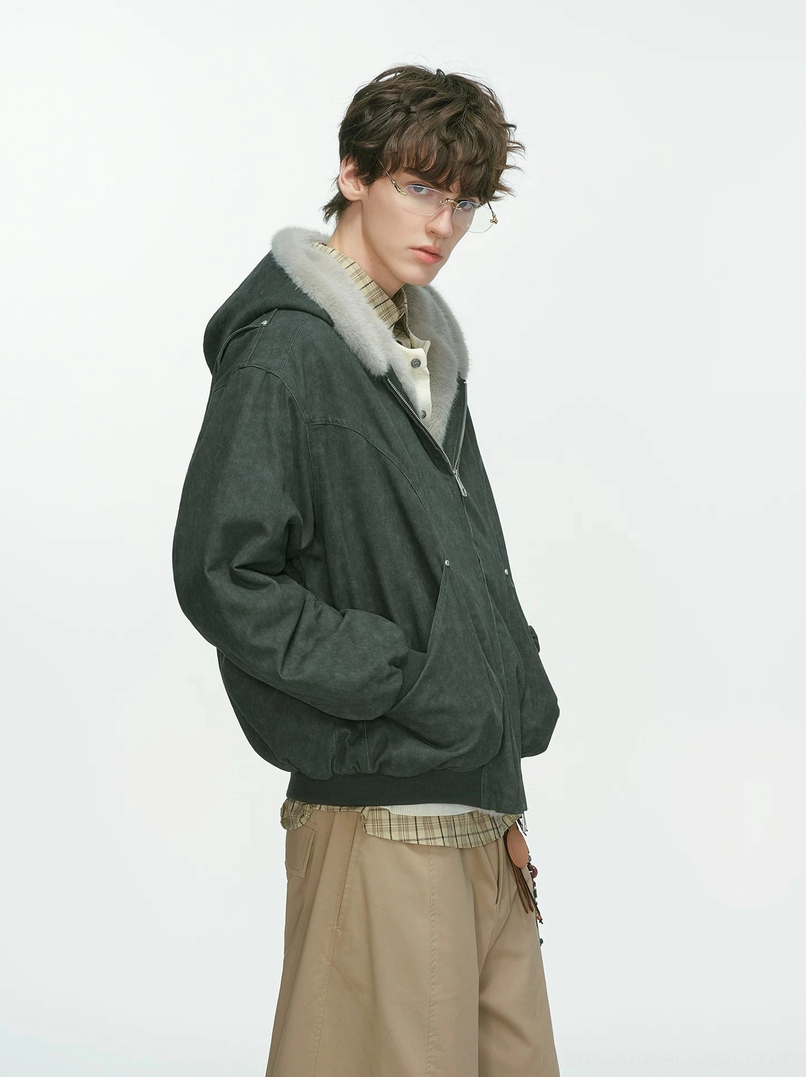 Dark gray faux-shearling lined hooded bomber jacket in relaxed winter streetwear fit side view