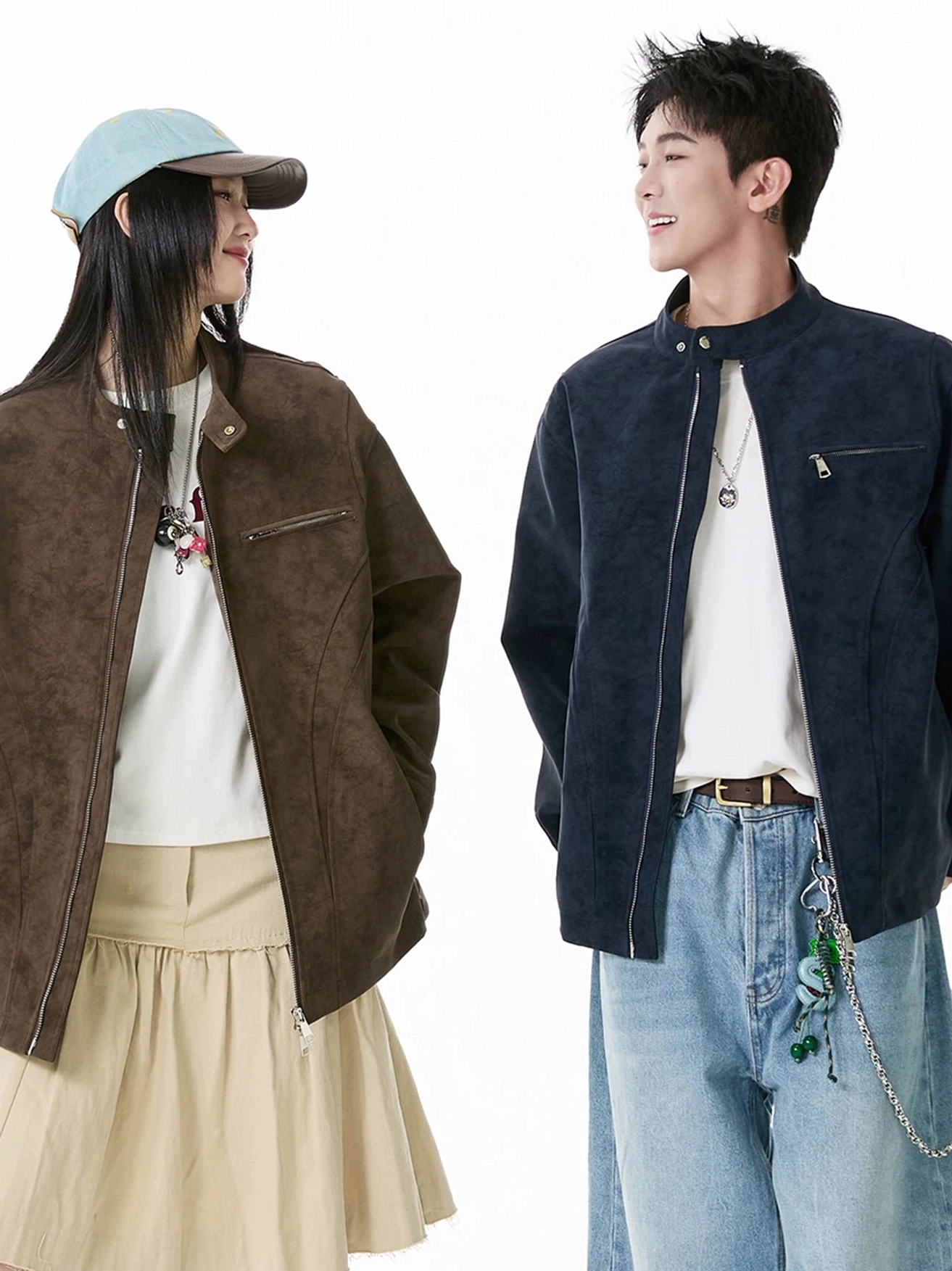 Couple wearing relaxed faux suede moto zip jackets with stand collars in a Korean streetwear studio lookbook