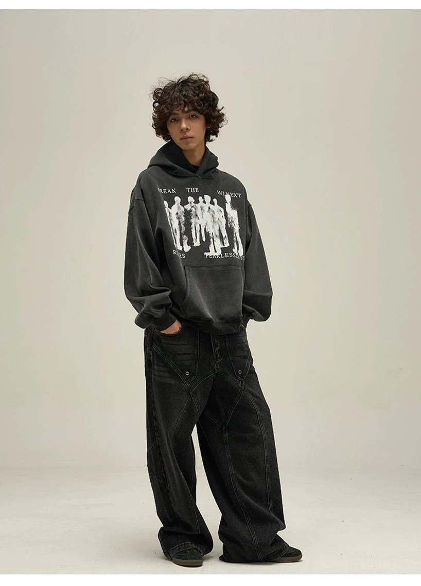 Washed black oversized graphic pullover hoodie side view showing relaxed dropped-shoulder streetwear fit