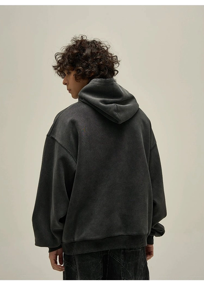 Washed black oversized hoodie back view showing clean solid back and relaxed streetwear silhouette