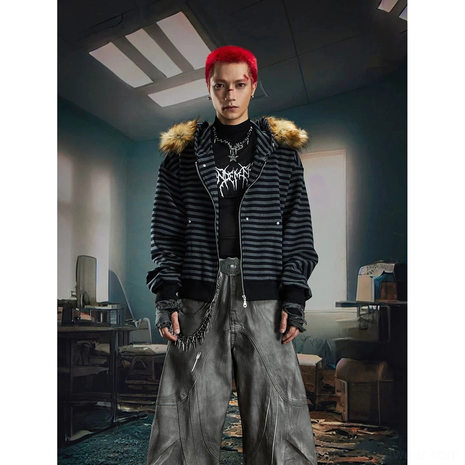 Front view of male model wearing relaxed black grey striped faux fur trim hooded zip-up jacket over graphic t-shirt